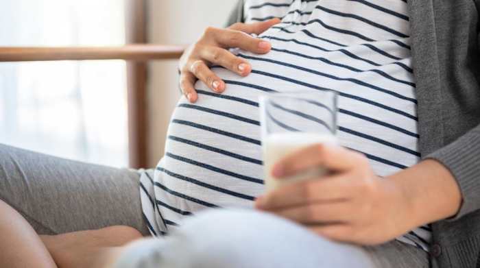 Pregnant woman drinking protein shake